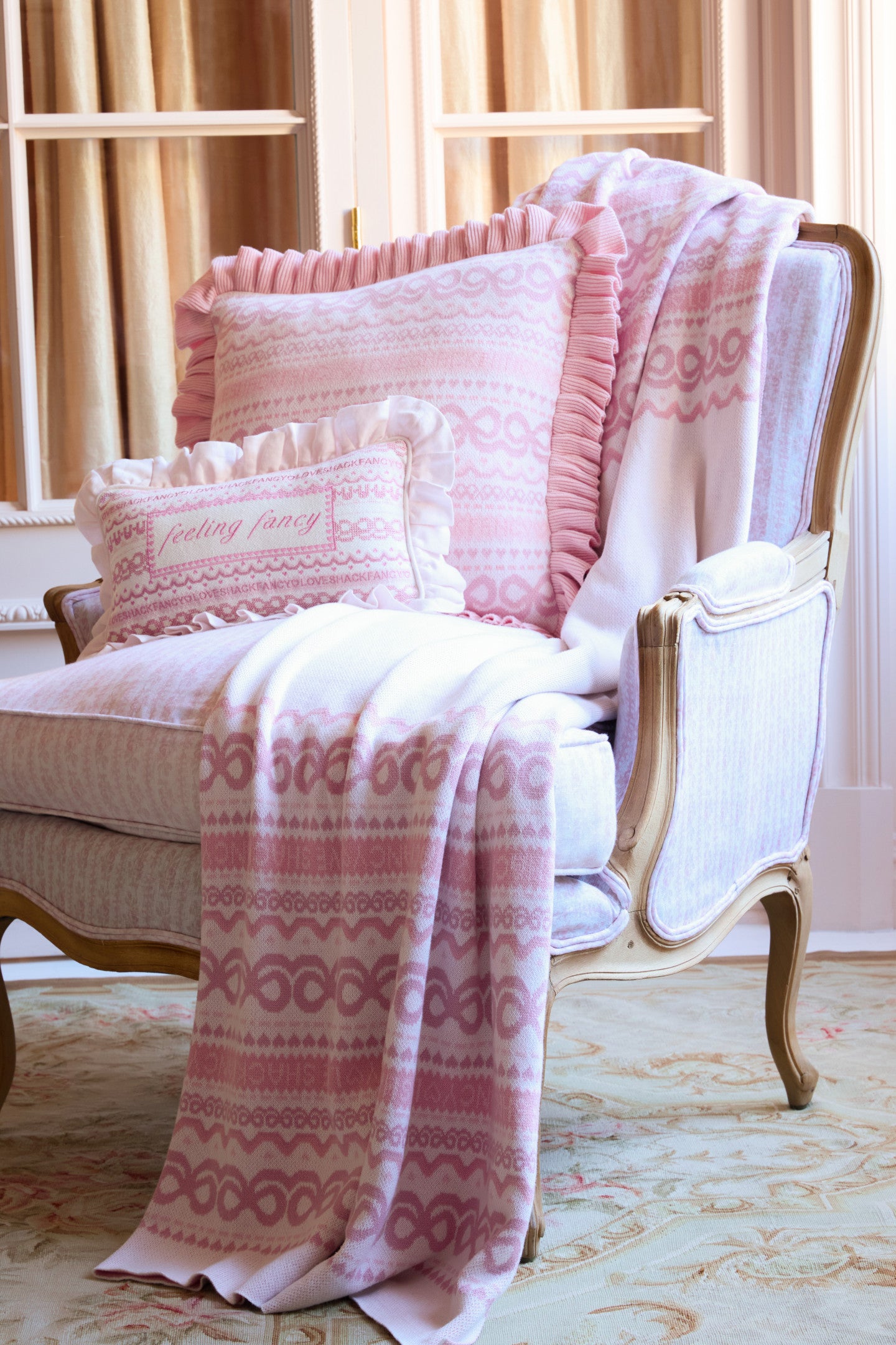 Women sitting in grass field wearing LoveShackFancy Slip Dresses