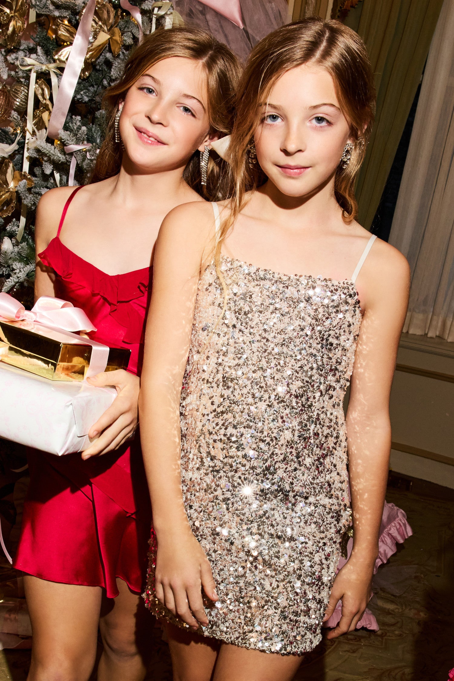 Women sitting in grass field wearing LoveShackFancy Slip Dresses