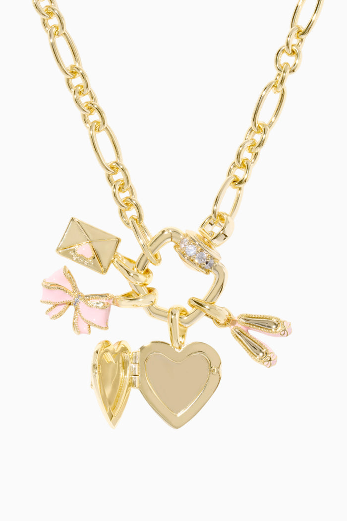 Gold necklace with heart-shaped pendants and a pink bow on a white background